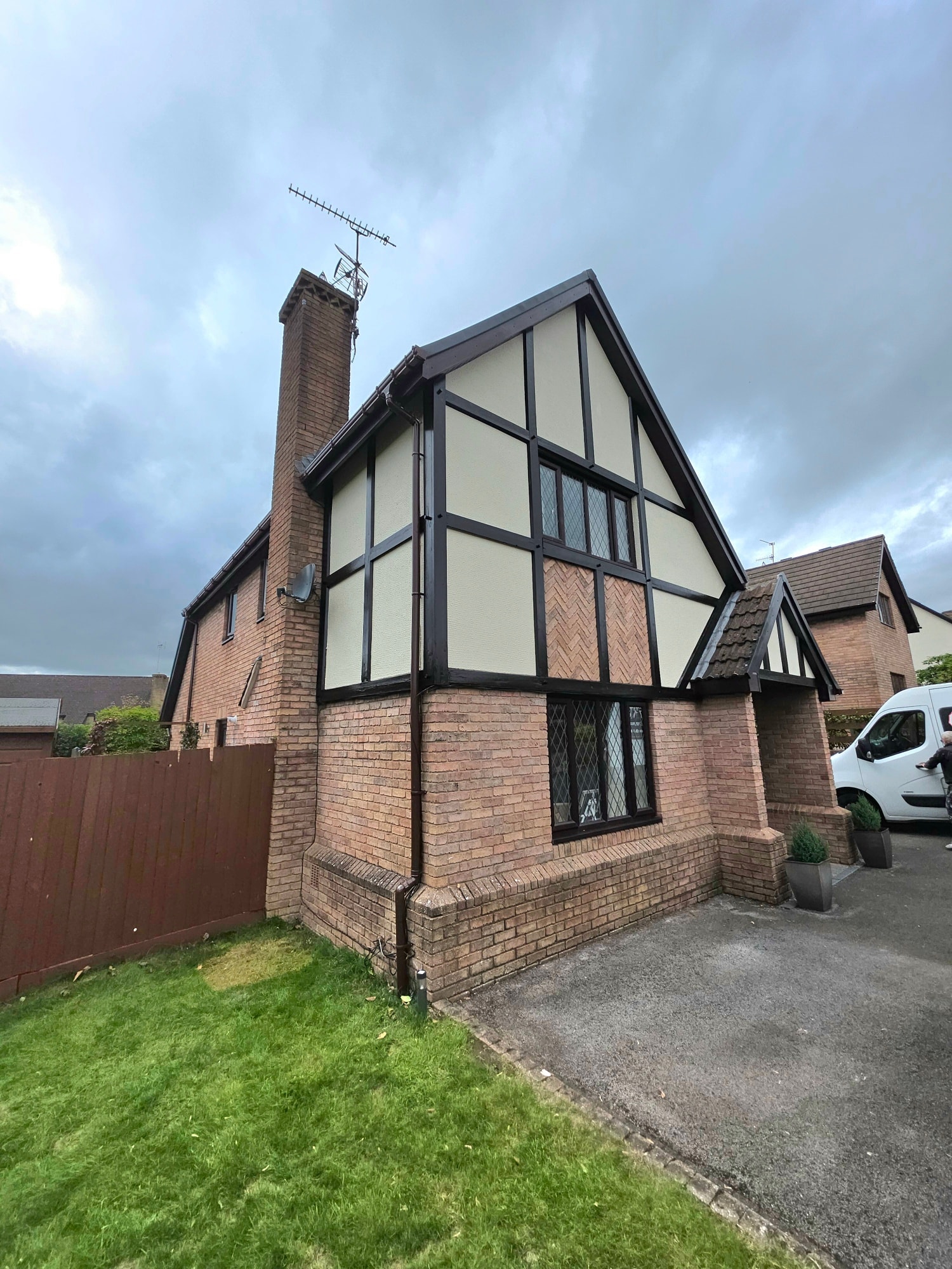 Side elevation of a repainted Tudor-style detached property in South Wales