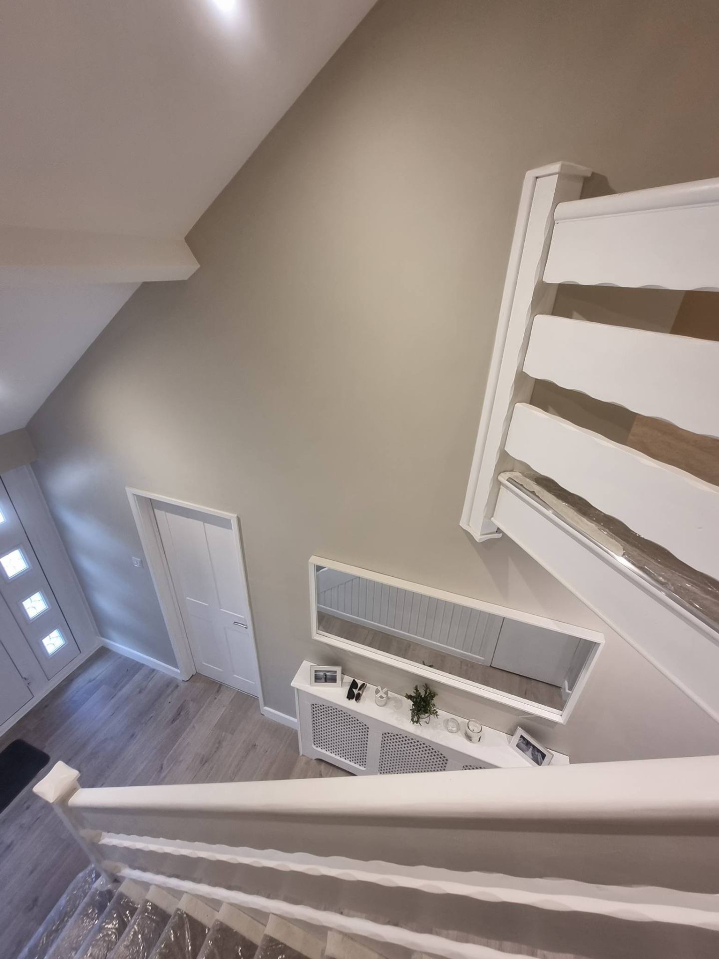 Stairs and landing repainted in a clean neutral palette across two storeys