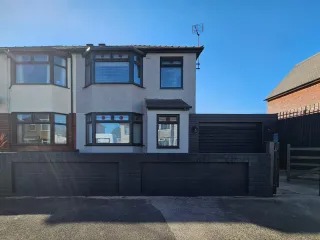 Modern home with grey render and dark UPVC after exterior refresh — serving Monmouthshire