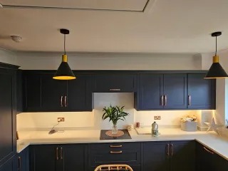 Sprayed navy shaker cabinets with brass pendant lighting